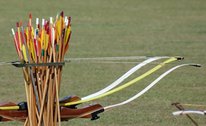 Ground quiver holding take-down recurve bows and wooden arrows, for use at a summer fete